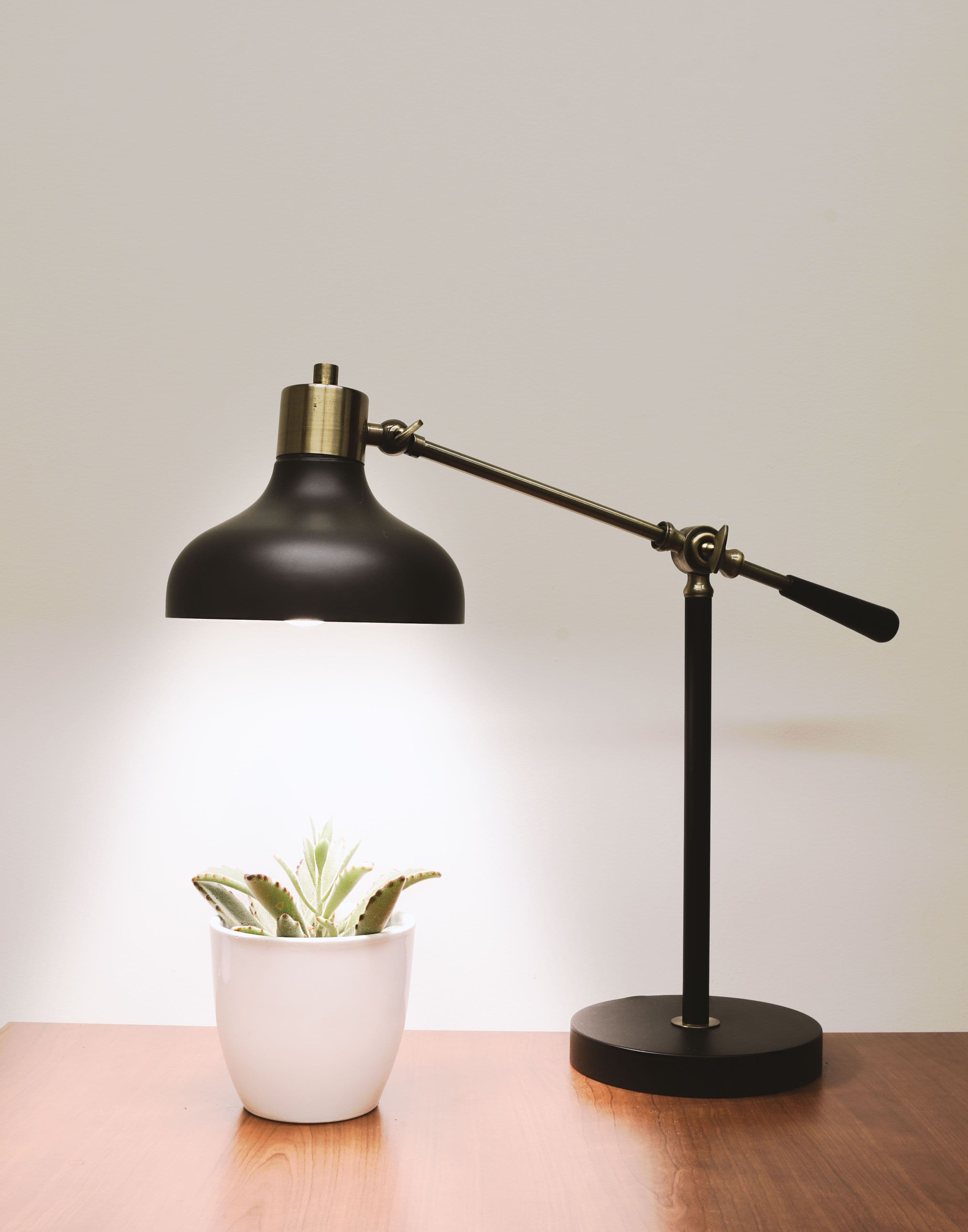A pendant light being assembled by hand at the LitMeUp workshop bench